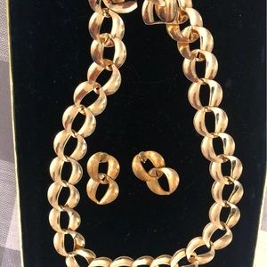 Three piece, gold tone, costume jewelry set. earrings bracelet, and necklace.